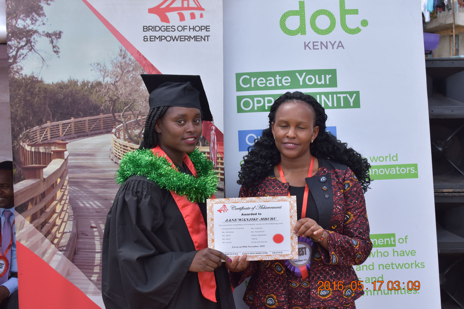 Two women holding a certificate and posing for the camera.