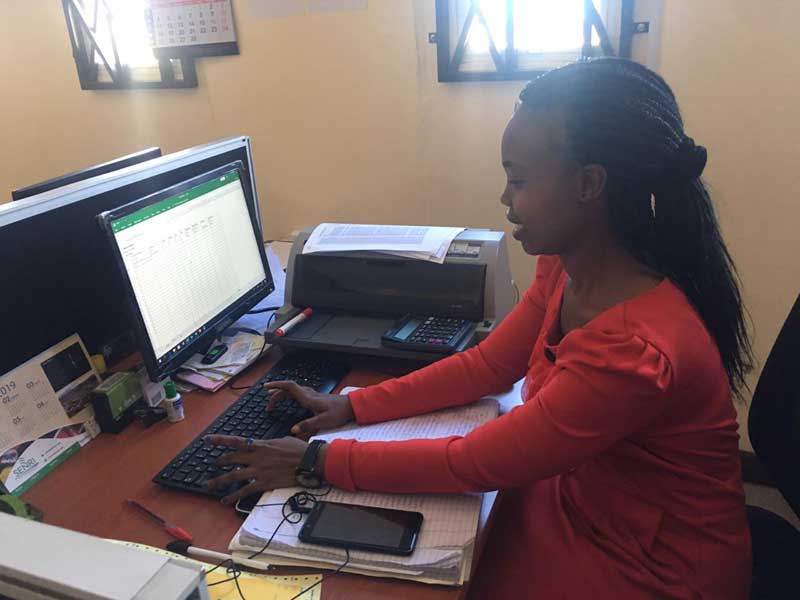 A woman sitting at a desk with a computer.