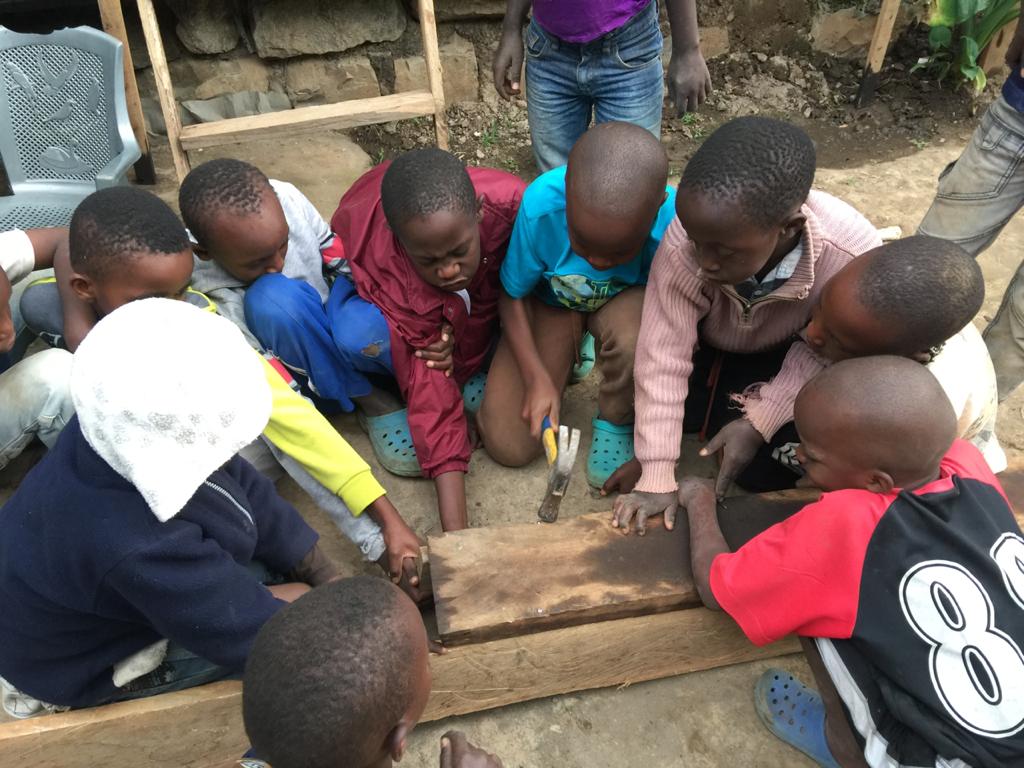 A group of children playing with wooden blocks.