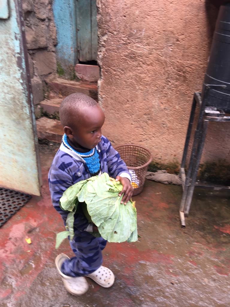 A young boy holding onto some clothes in his hands