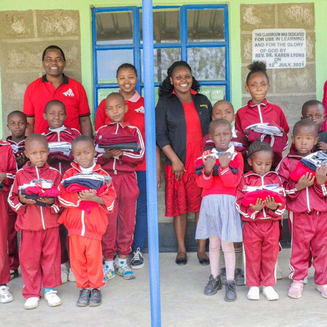 A group of children in red uniforms standing next to each other.